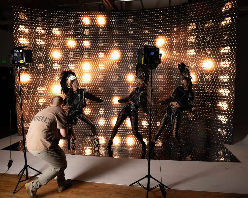 Illuminated event stage with performers — sponsor logo visibility surface