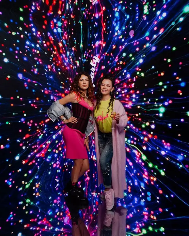 Illuminated event stage with performers — sponsor logo visibility surface